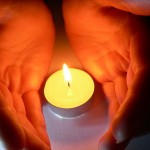 hands and a candle Social Media Obituary